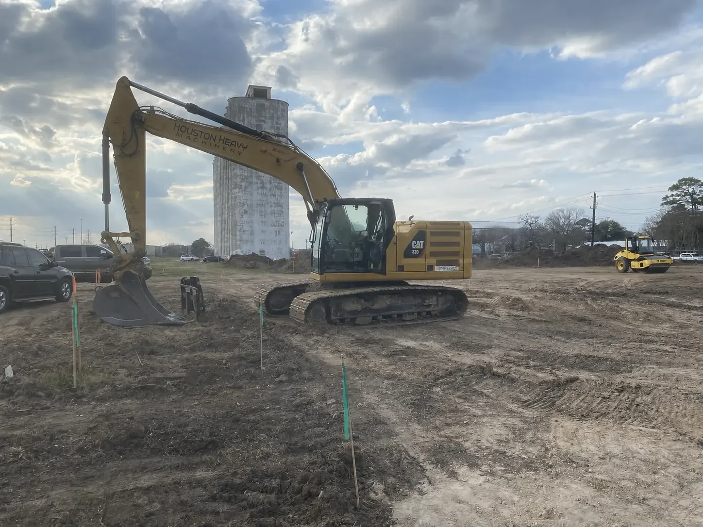 CAT excavator positioned on a graded construction site.