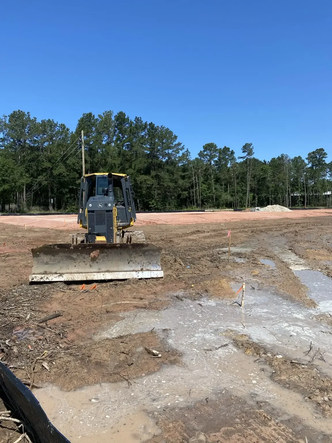 Bulldozer grading a large construction site.